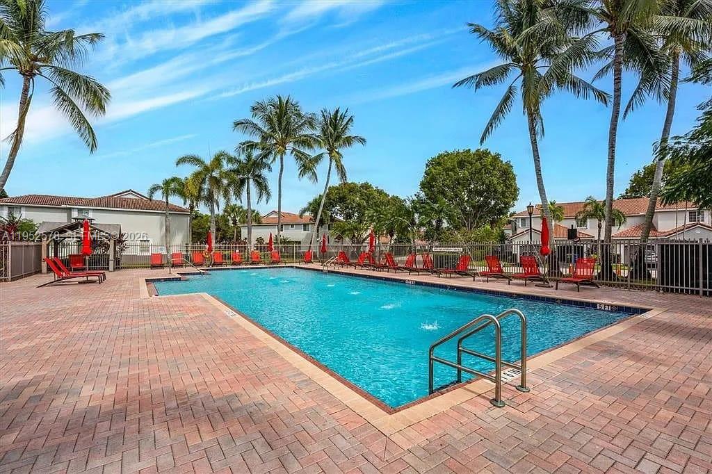 3618 San Simeon Circle, Unit 3618 Weston, FL 33331 - Photo 41 of 44 a view of a swimming pool with a table and chairs