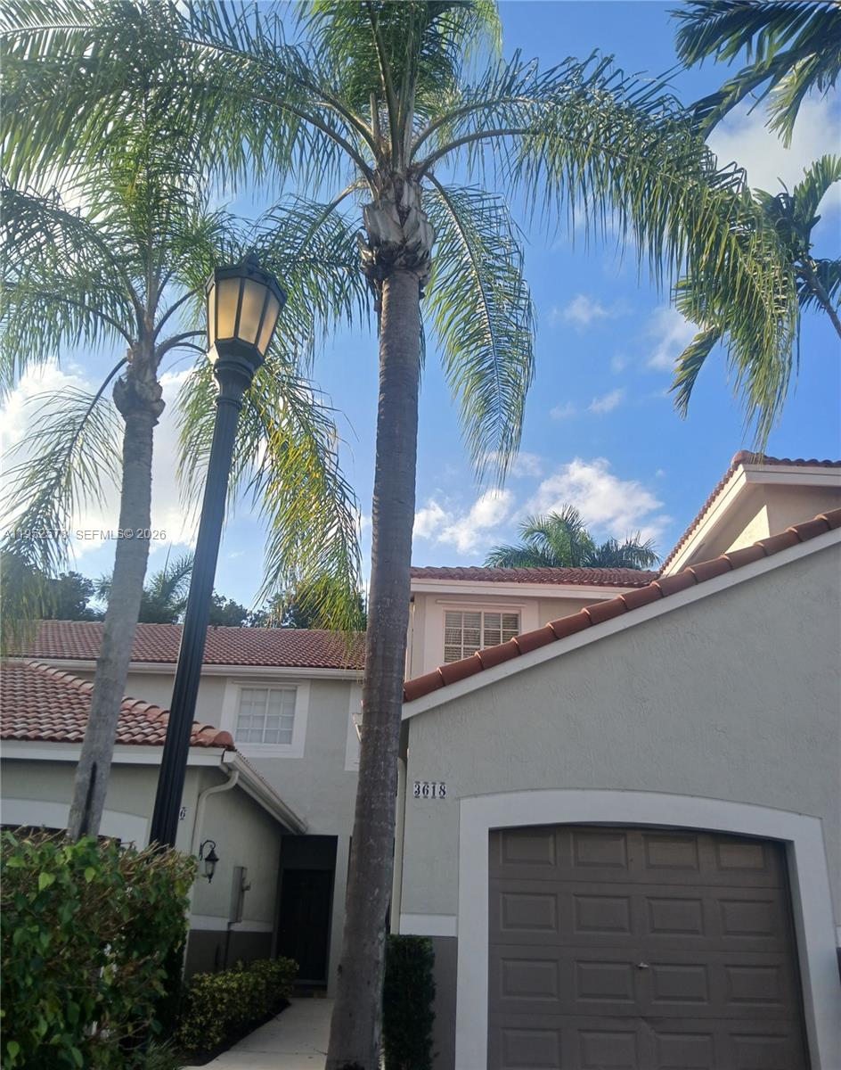 3618 San Simeon Circle, Unit 3618 Weston, FL 33331 - Photo 9 of 44 a palm tree sitting in front of a house