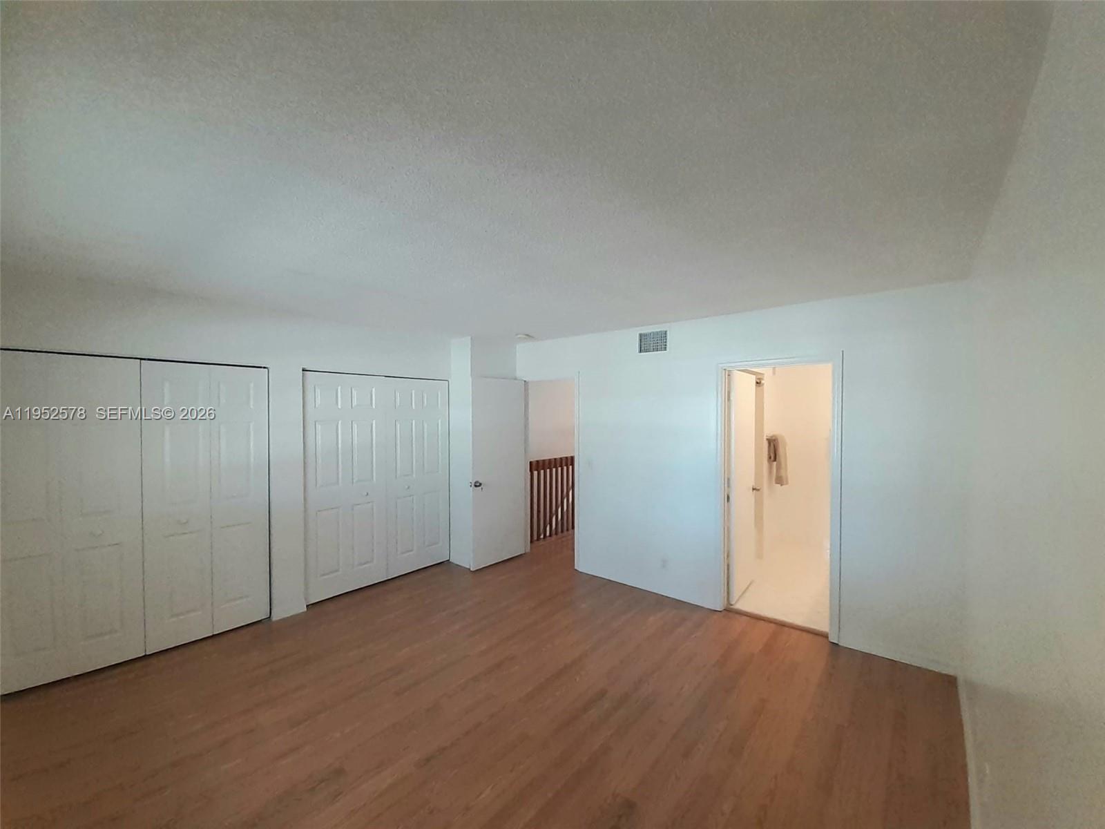 3618 San Simeon Circle, Unit 3618 Weston, FL 33331 - Photo 10 of 44 a view of an empty room and wooden floor