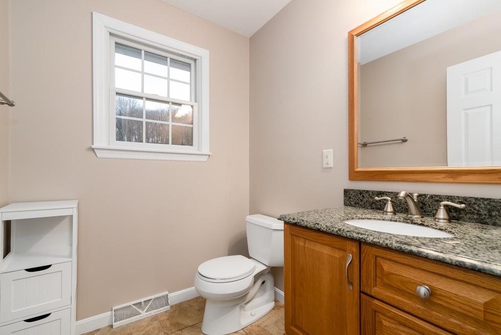 116 West Cruikshank Road Butler, PA 16002 - Photo 21 of 25 a bathroom with a granite countertop toilet sink and mirror