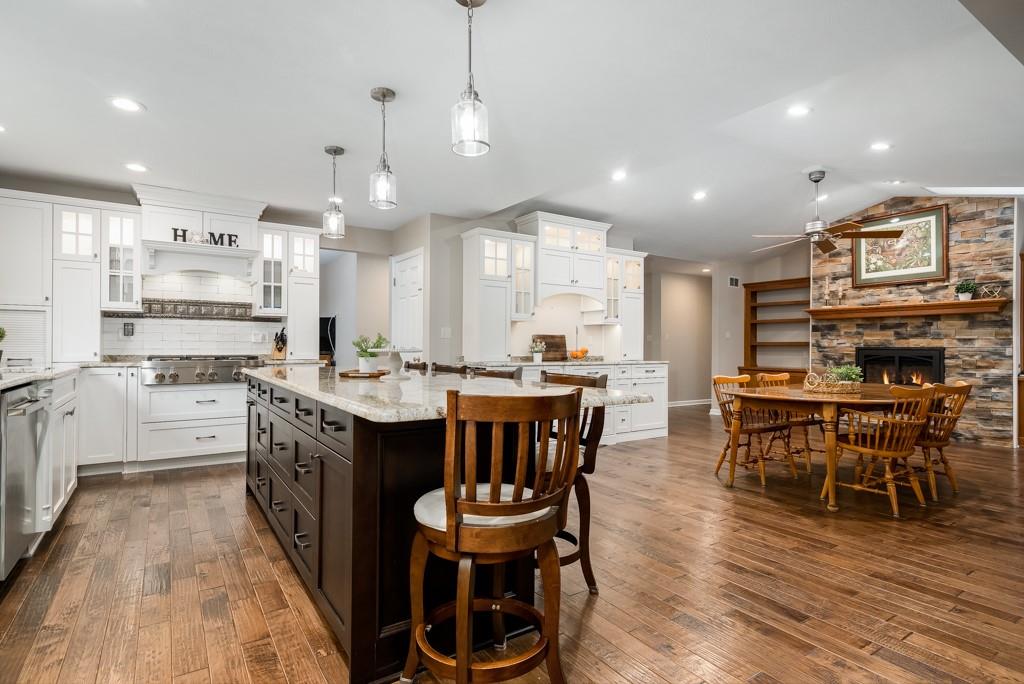 116 West Cruikshank Road Butler, PA 16002 - Photo 5 of 25 a open kitchen with stainless steel appliances granite countertop a stove a sink dishwasher a dining table and chairs with wooden floor