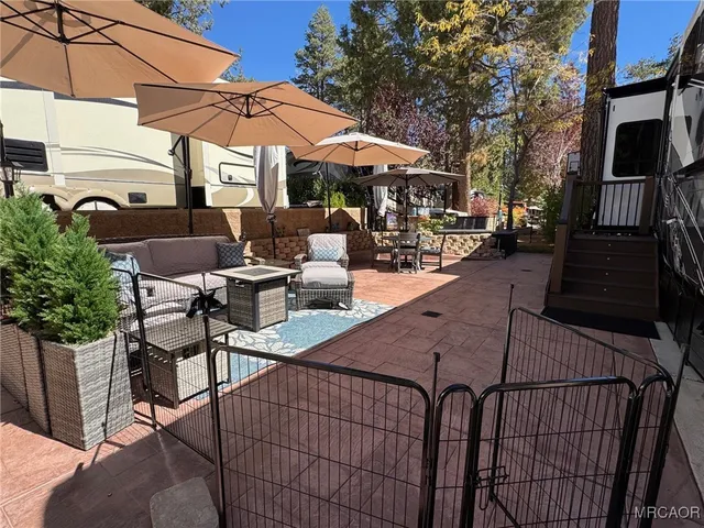 a view of a patio with table and chairs under an umbrella