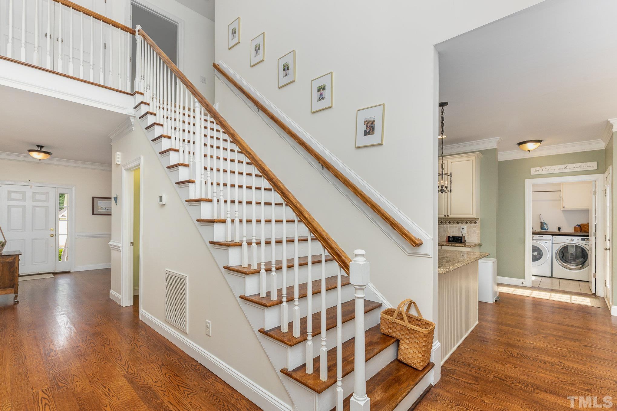 1308 Red Brick Road Garner, NC 27529 - Photo 11 of 31 a view of an entryway with wooden floor and stairs