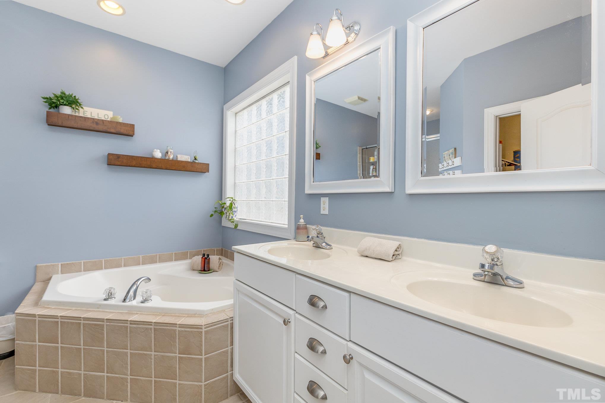 1308 Red Brick Road Garner, NC 27529 - Photo 14 of 31 a bathroom with a sink and a mirror