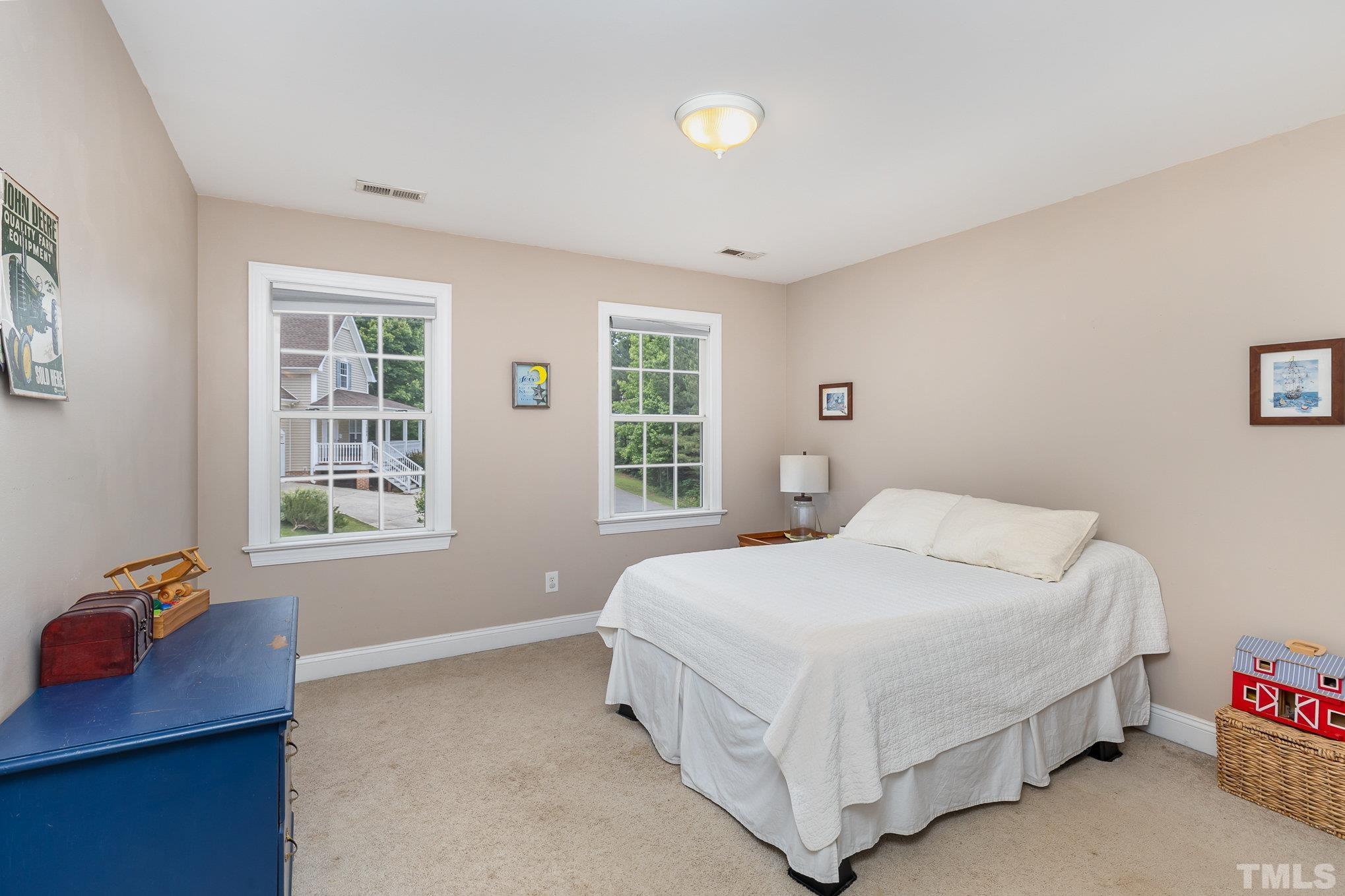 1308 Red Brick Road Garner, NC 27529 - Photo 17 of 31 a bedroom with a bed and with windows
