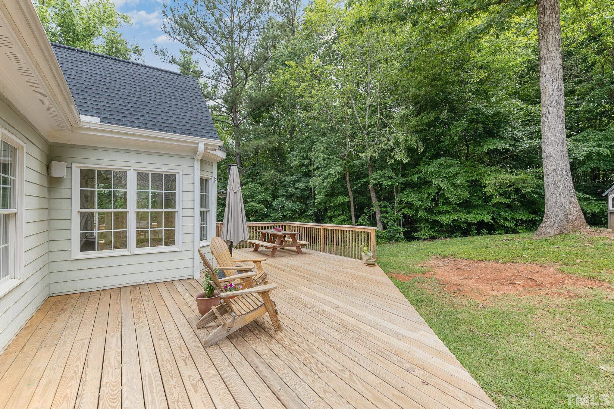 1308 Red Brick Road Garner, NC 27529 - Photo 20 of 31 a view of a patio with table and chairs with wooden floor and fence