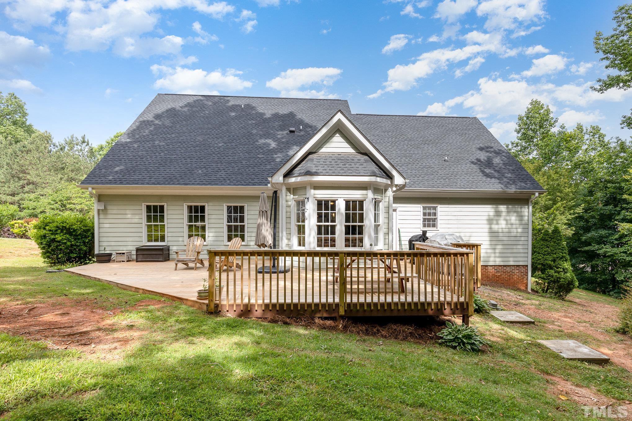1308 Red Brick Road Garner, NC 27529 - Photo 21 of 31 a view of a house with a yard and deck