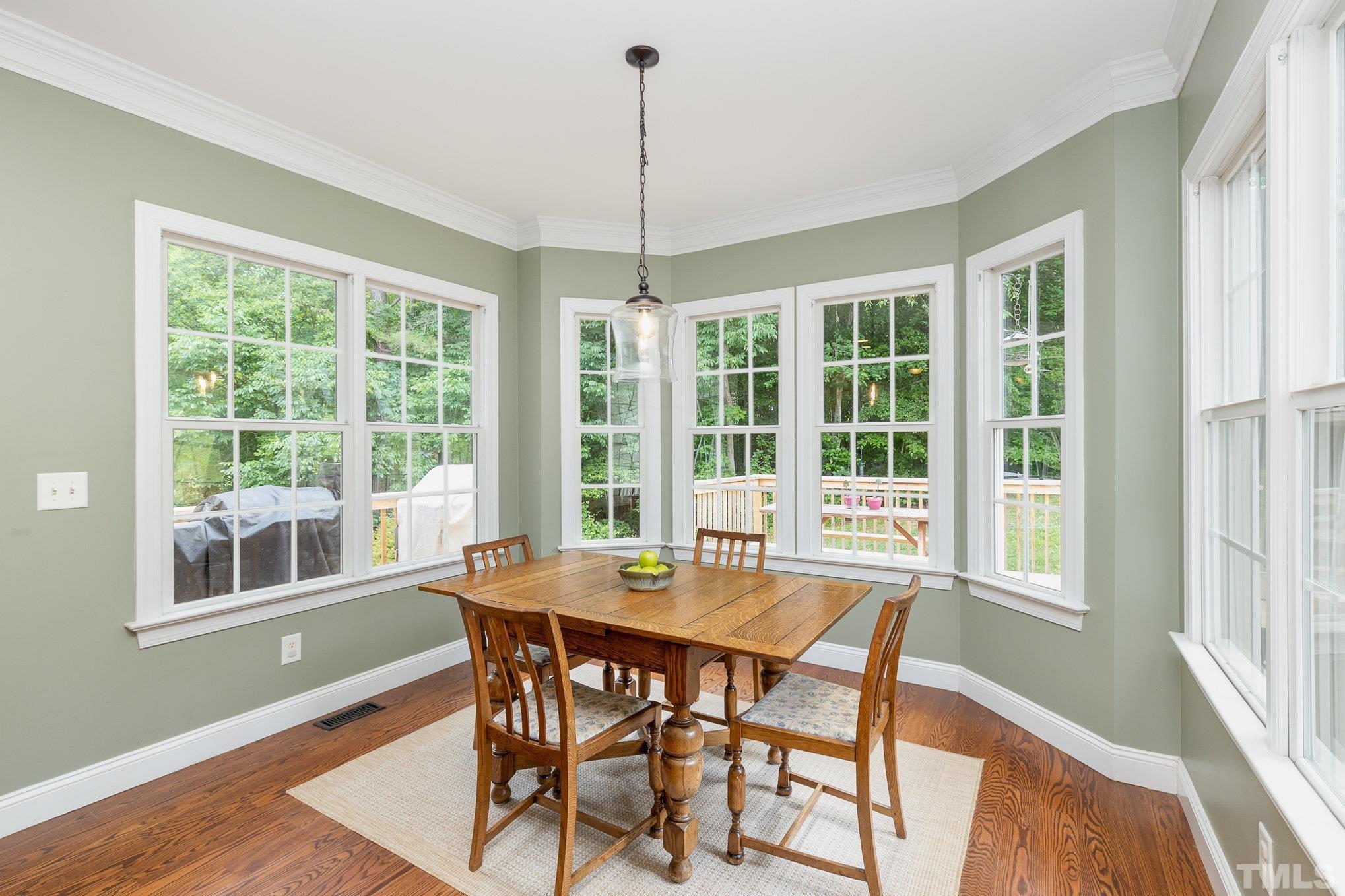 1308 Red Brick Road Garner, NC 27529 - Photo 6 of 31 a dining room with furniture large windows and wooden floor