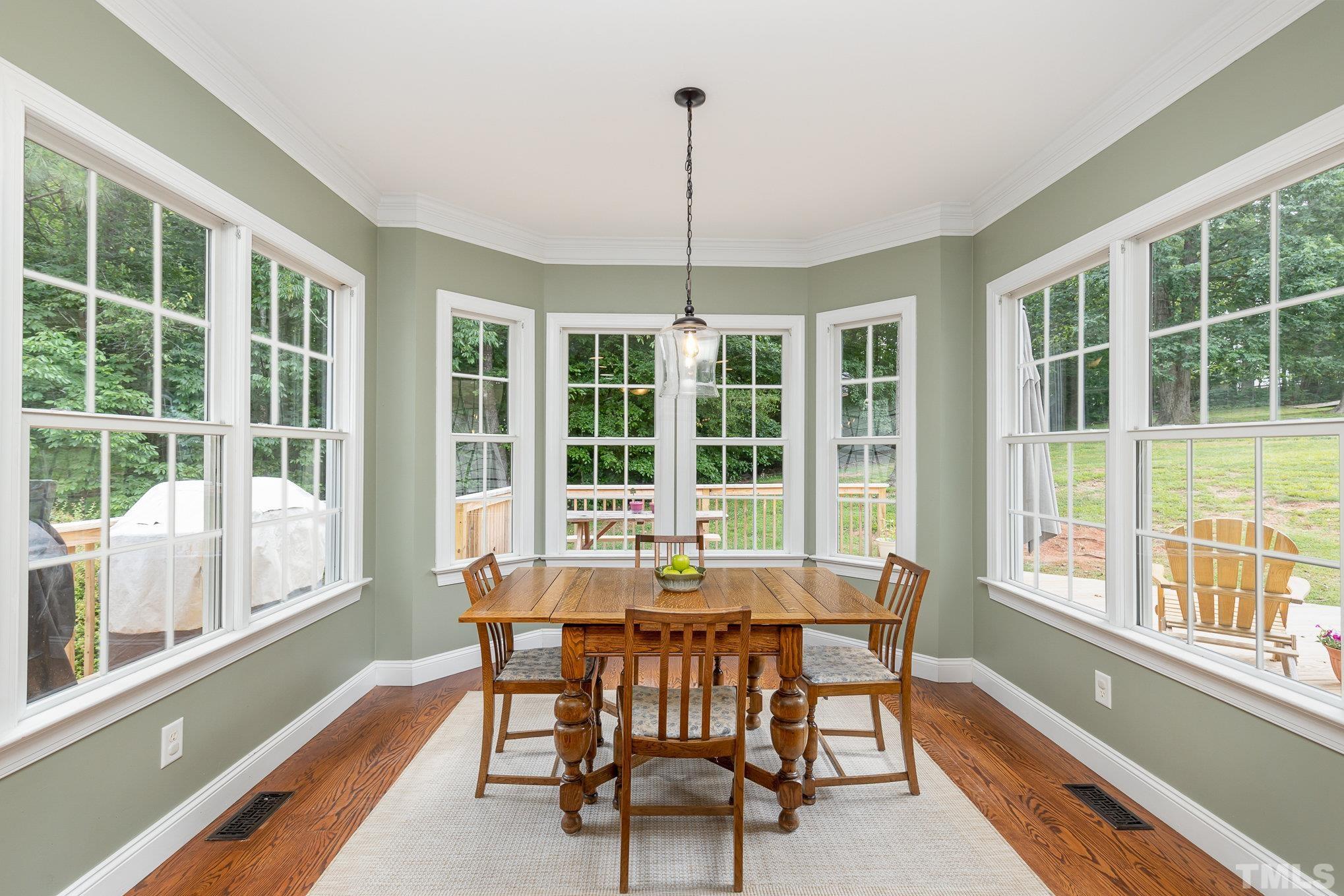 1308 Red Brick Road Garner, NC 27529 - Photo 7 of 31 a dining room with furniture large windows and wooden floor