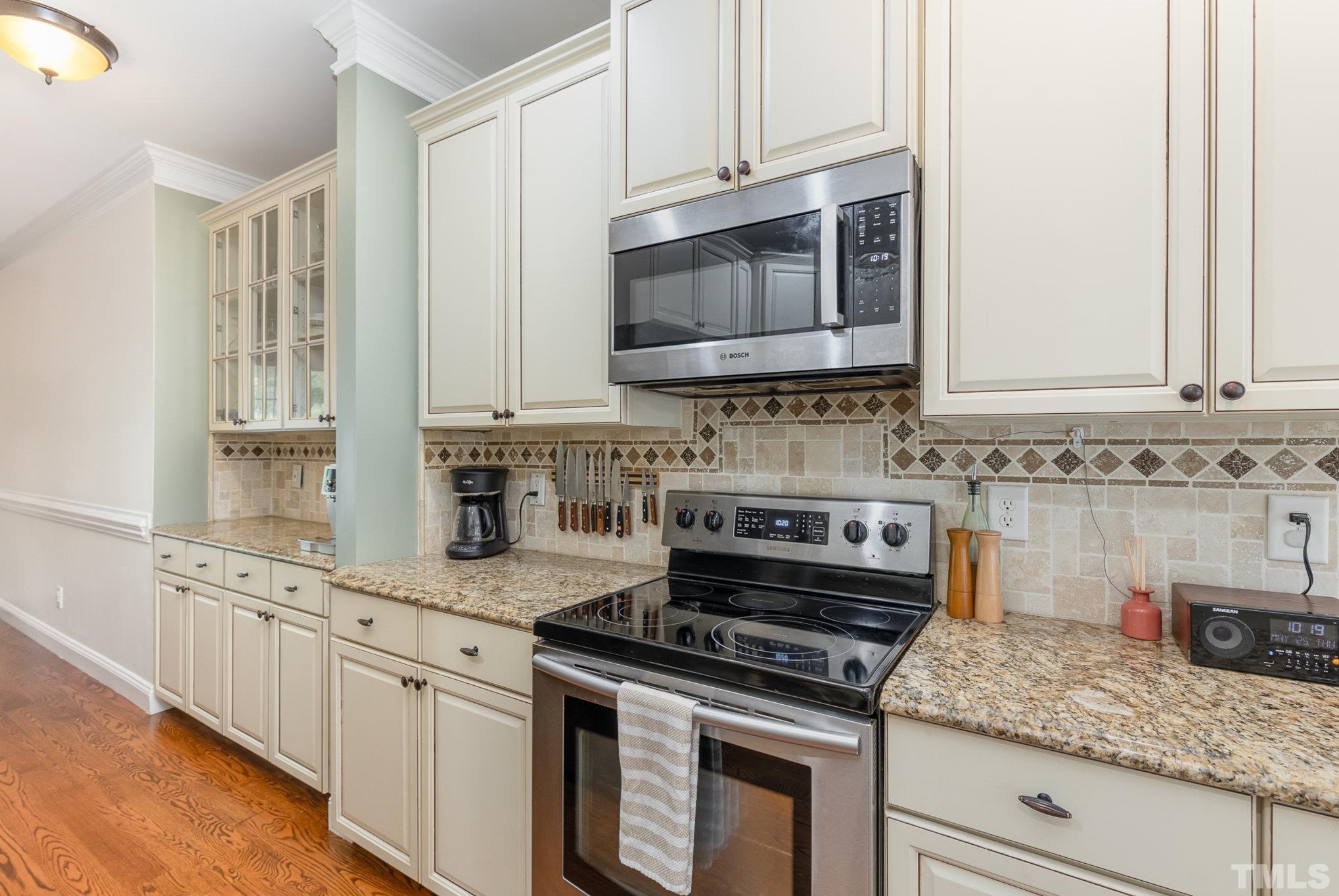 1308 Red Brick Road Garner, NC 27529 - Photo 10 of 31 a kitchen with granite countertop white cabinets and a stove top oven