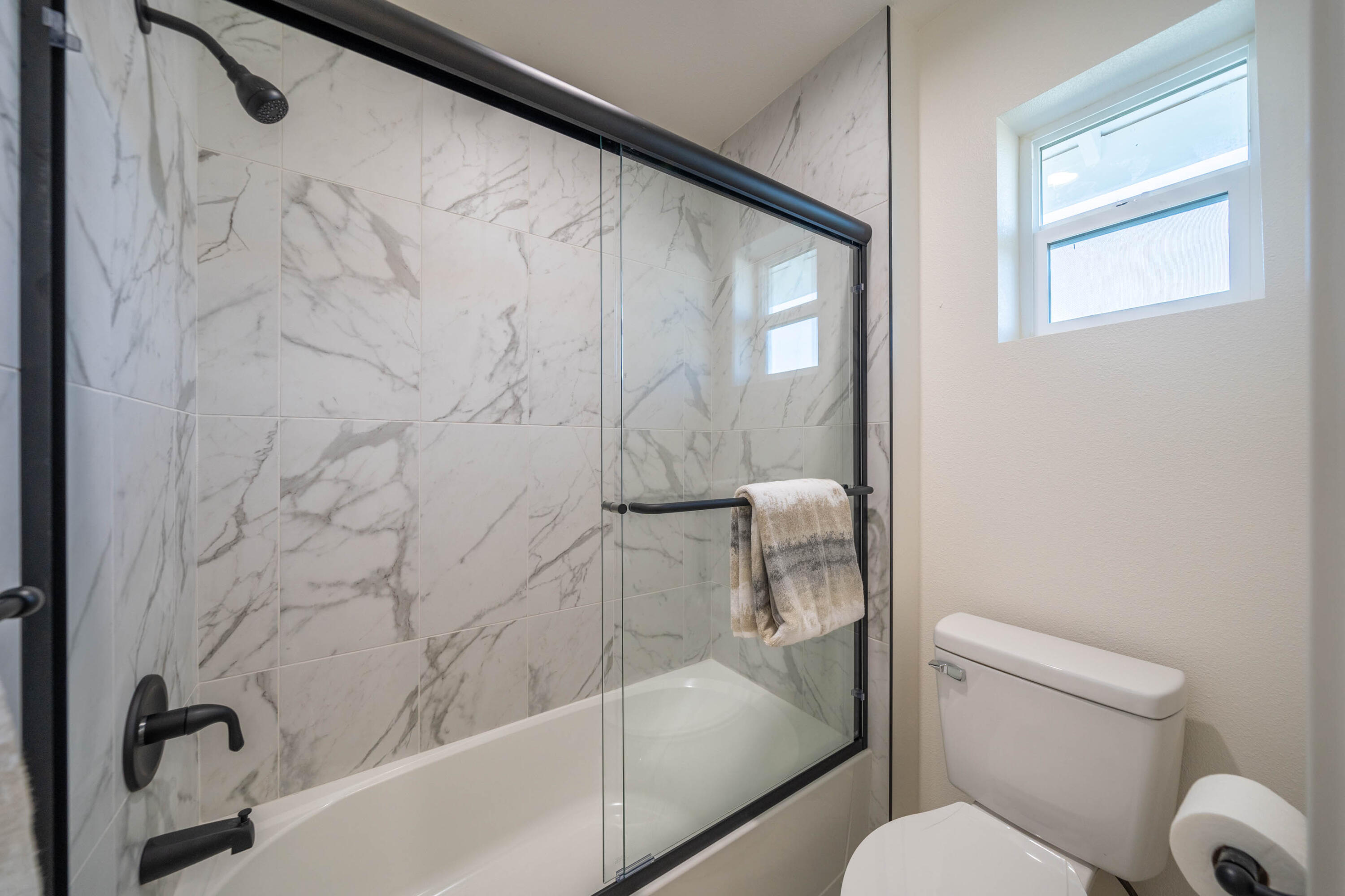 1387 Ridge Drive Redding, CA 96001 - Photo 25 of 44 a bathroom with a toilet and a bathtub