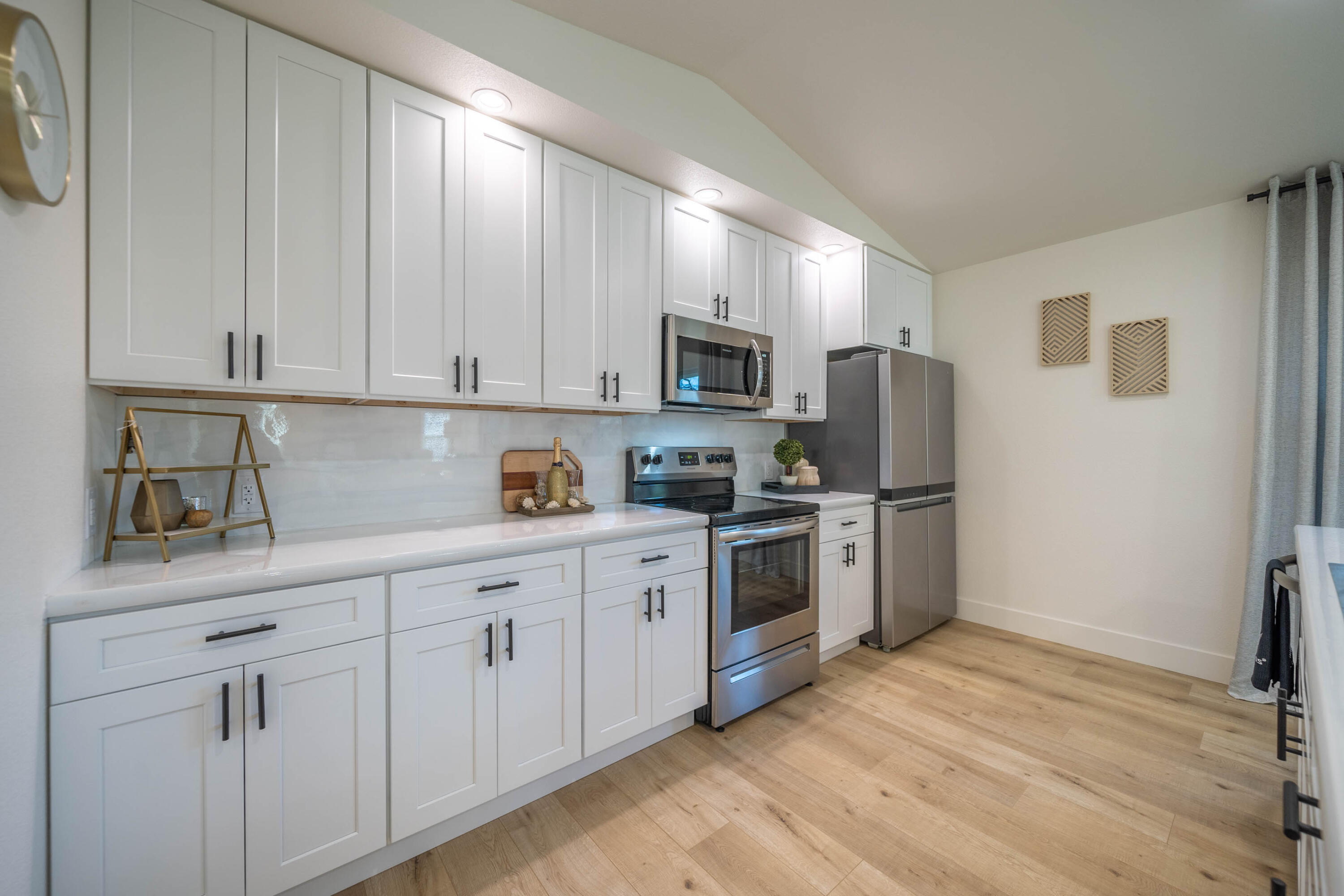 1387 Ridge Drive Redding, CA 96001 - Photo 7 of 44 a kitchen with granite countertop white cabinets stainless steel appliances and sink