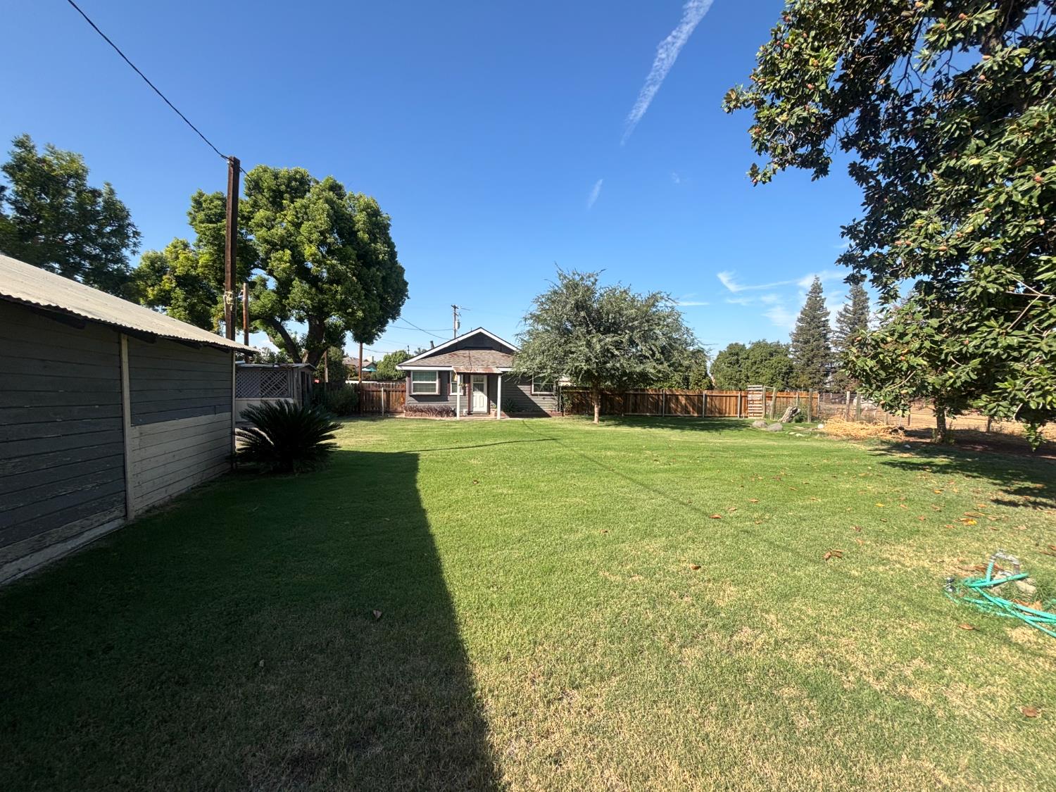 19317 East Parlier Avenue Reedley, CA 93654 - Photo 14 of 36 a front view of a house with garden