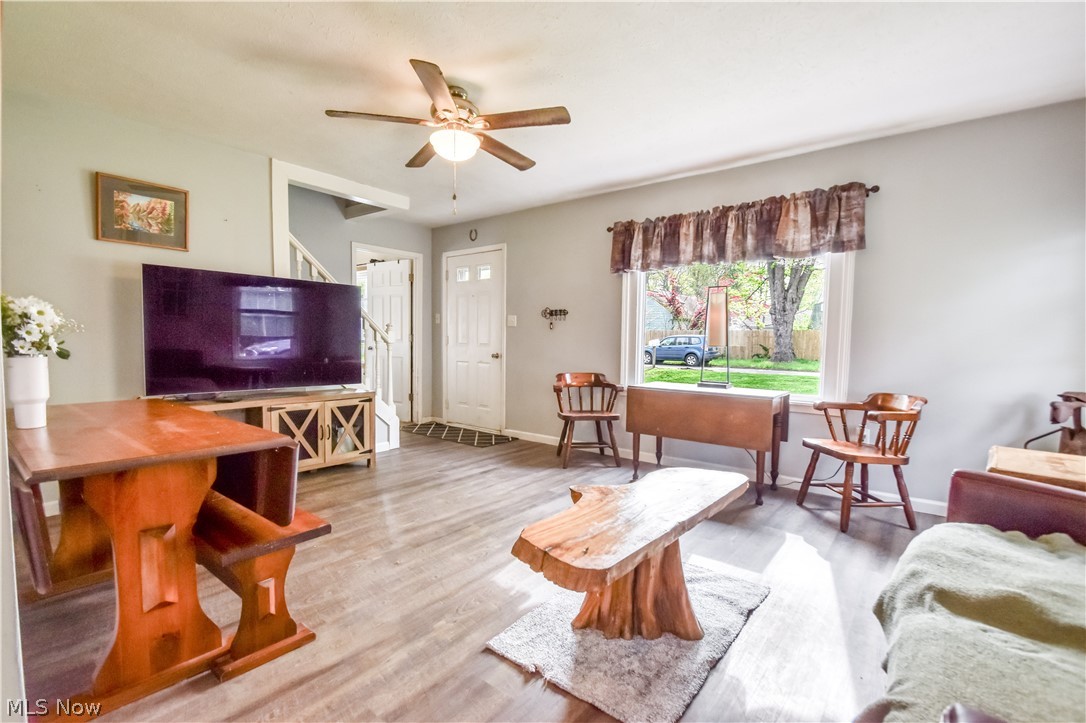 1969 Paisley Road Madison, OH 44057 - Photo 7 of 20 Open living area featuring wood-finish flooring, light grey walls, and a large window
