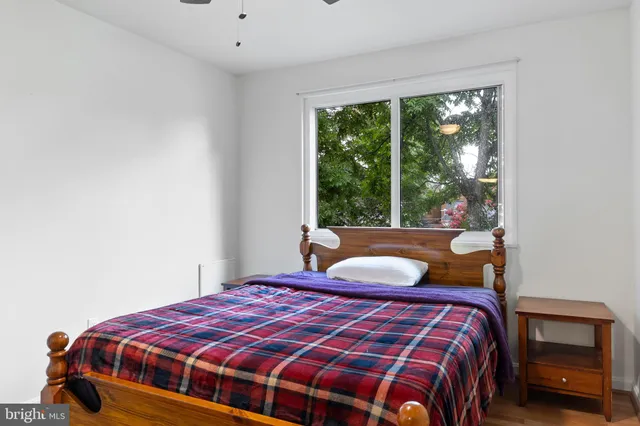 a bedroom with a bed and a window