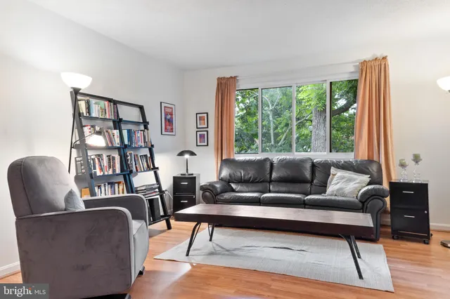 a living room with furniture and a book shelf