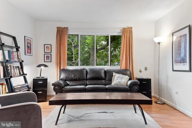 a living room with furniture and a book shelf
