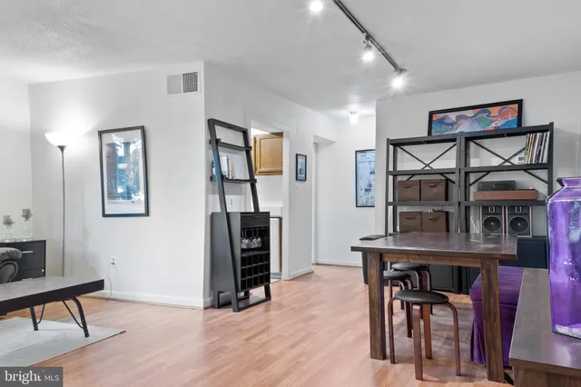 a view of a workspace with furniture and wooden floor