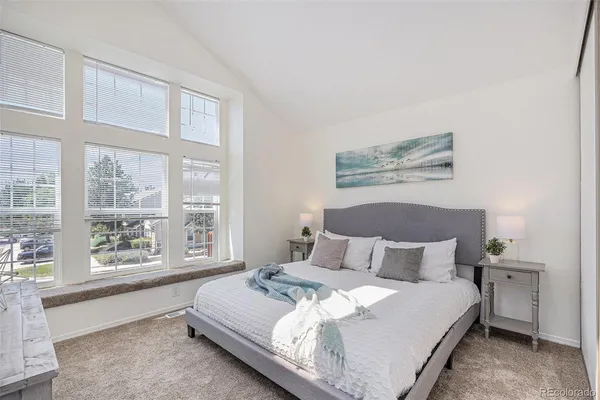 a bedroom with a large bed and a large window