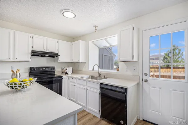 a kitchen with a sink stove and cabinets