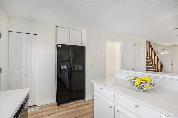 a kitchen with a refrigerator and a stove