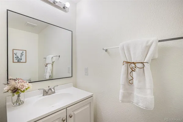 a bathroom with a sink vanity and a mirror