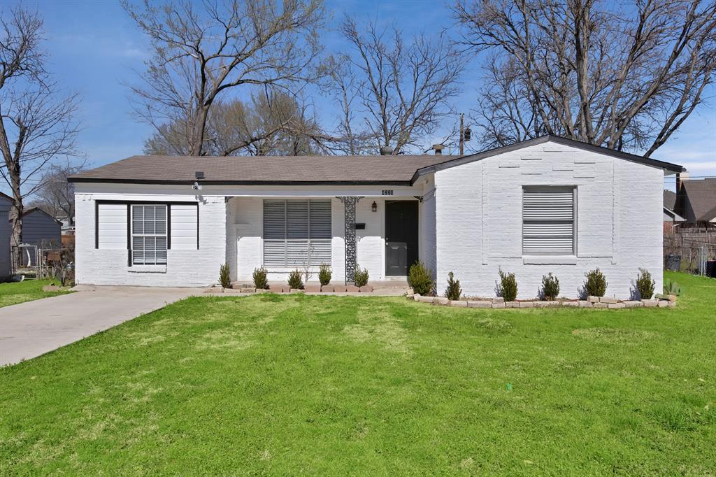 View of front of home with a front yard and brick siding