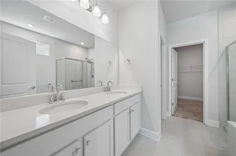 a bathroom with a sink double vanity and a mirror