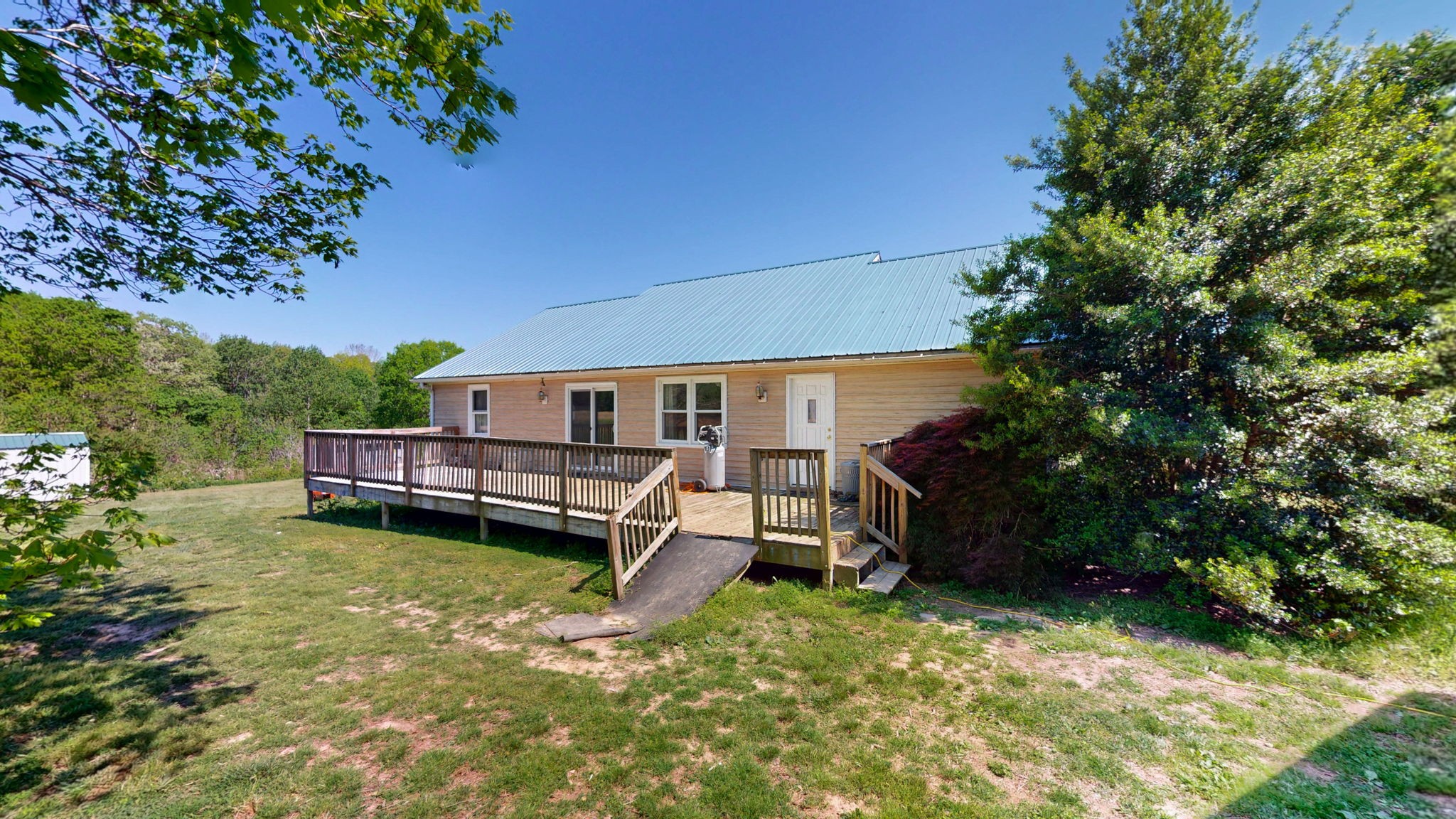 881 Coaling Road Charlotte, TN 37036 - Photo 22 of 29 view of a house with a backyard porch and sitting area