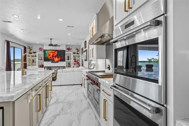 a kitchen with stainless steel appliances granite countertop a sink and stove