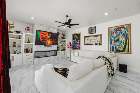 a kitchen with stainless steel appliances kitchen island granite countertop a dining table chairs and a refrigerator