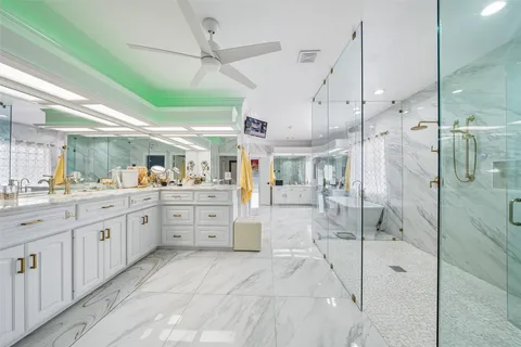 a large white tub sitting in a bathroom