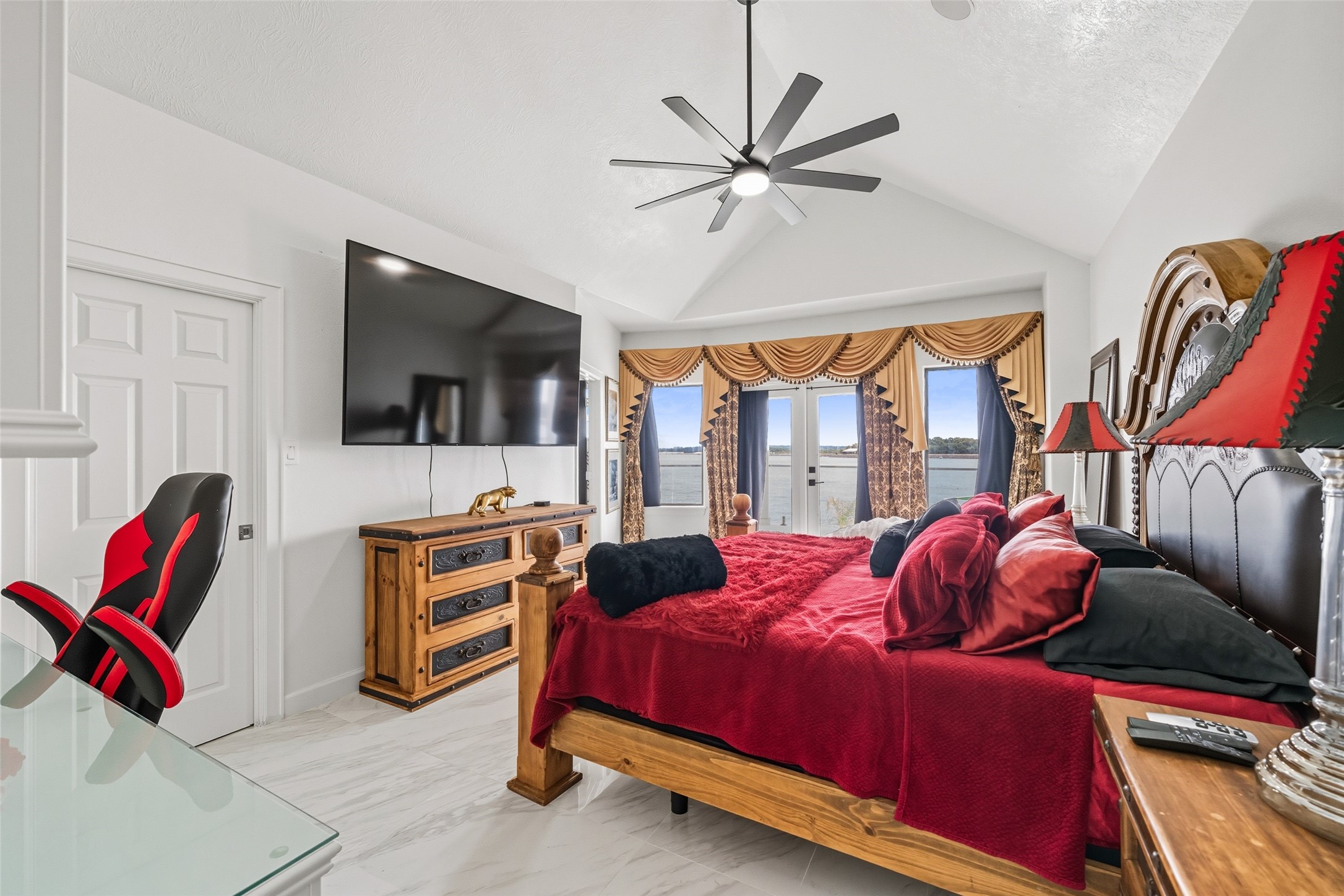 2500 Sand Shore Drive Conroe, TX 77304 - Photo 39 of 50 a bedroom with a bed and a flat screen tv