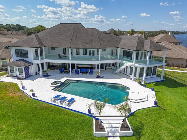 an aerial view of a house with swimming pool and big yard
