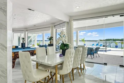 a view of a dining room with furniture large windows and wooden floor