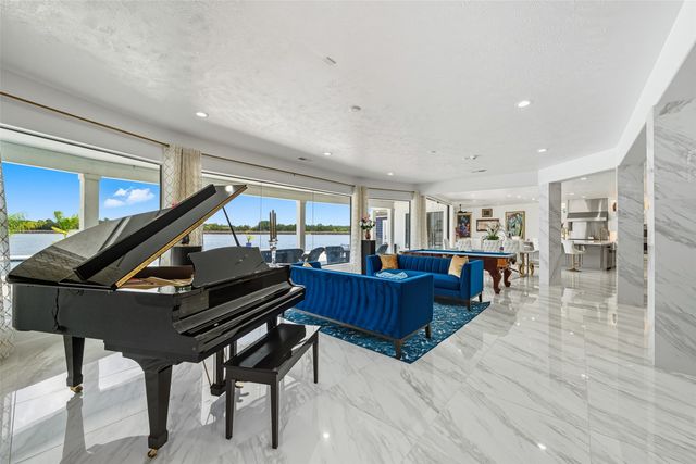 a living room with lots of furniture and a large window