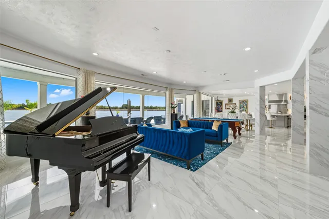 a living room with lots of furniture and a large window