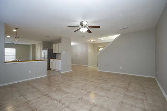 a view of a kitchen with a sink and a refrigerator