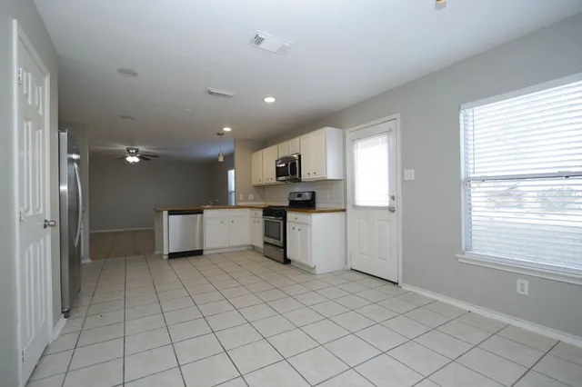 a view of a kitchen with a sink and dishwasher cabinets