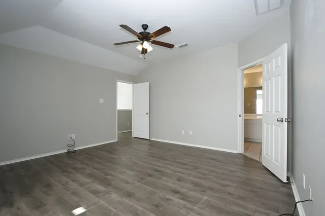 a spacious bathroom with a shower a sink and a mirror
