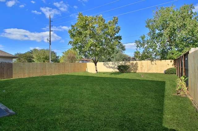 a front view of a house with a garden and plants