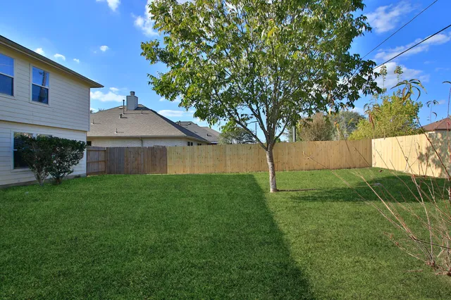 a house is sitting in middle od the grass