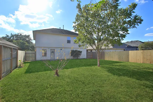 a house is sitting in middle od the grass