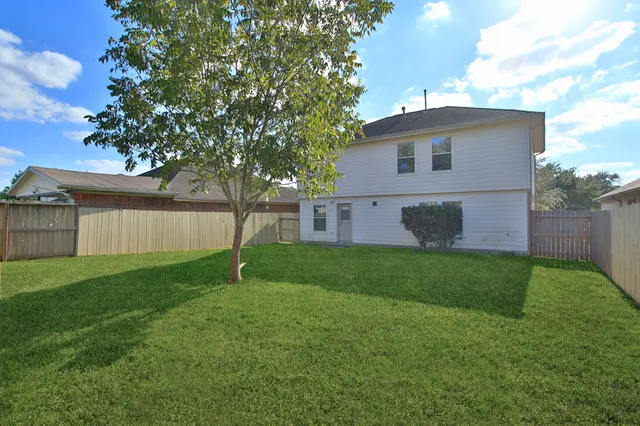 a view of yard with grass and a trees