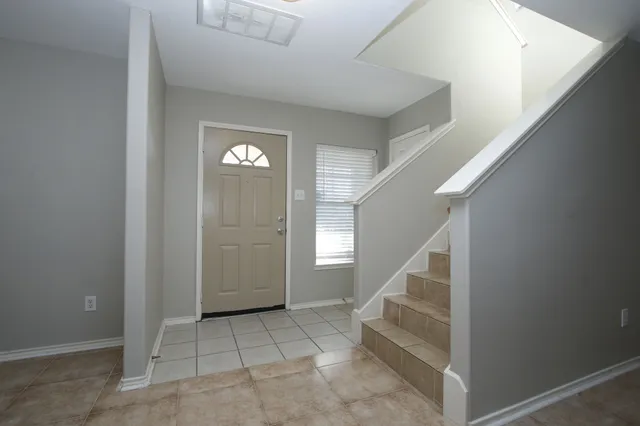 a view of entryway and hall with a living room