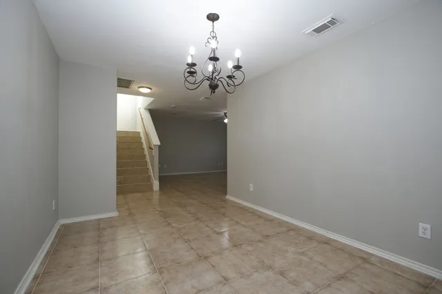 a view of a chandelier in big room and chandelier