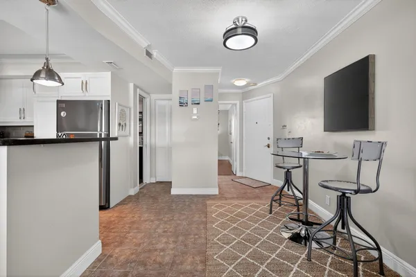 a kitchen with kitchen island white cabinets and stainless steel appliances