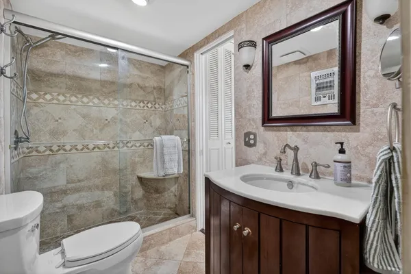 a bathroom with a toilet sink and shower