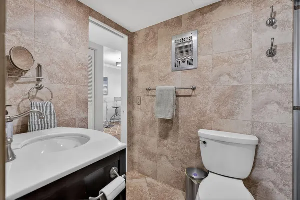 a bathroom with a toilet a sink and shower
