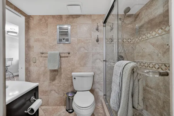 a bedroom with a bed and a ceiling fan